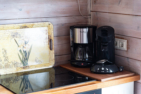 Moderne Küche im Ferienhaus 'Zweite Heimat' mit Herd und Kaffeeautomat, ideal für den Morgen.